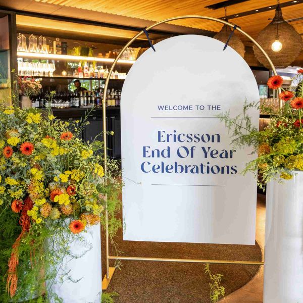 A beautifully decorated event sign displaying 'Welcome to the Ericsson End of Year Celebrations'.