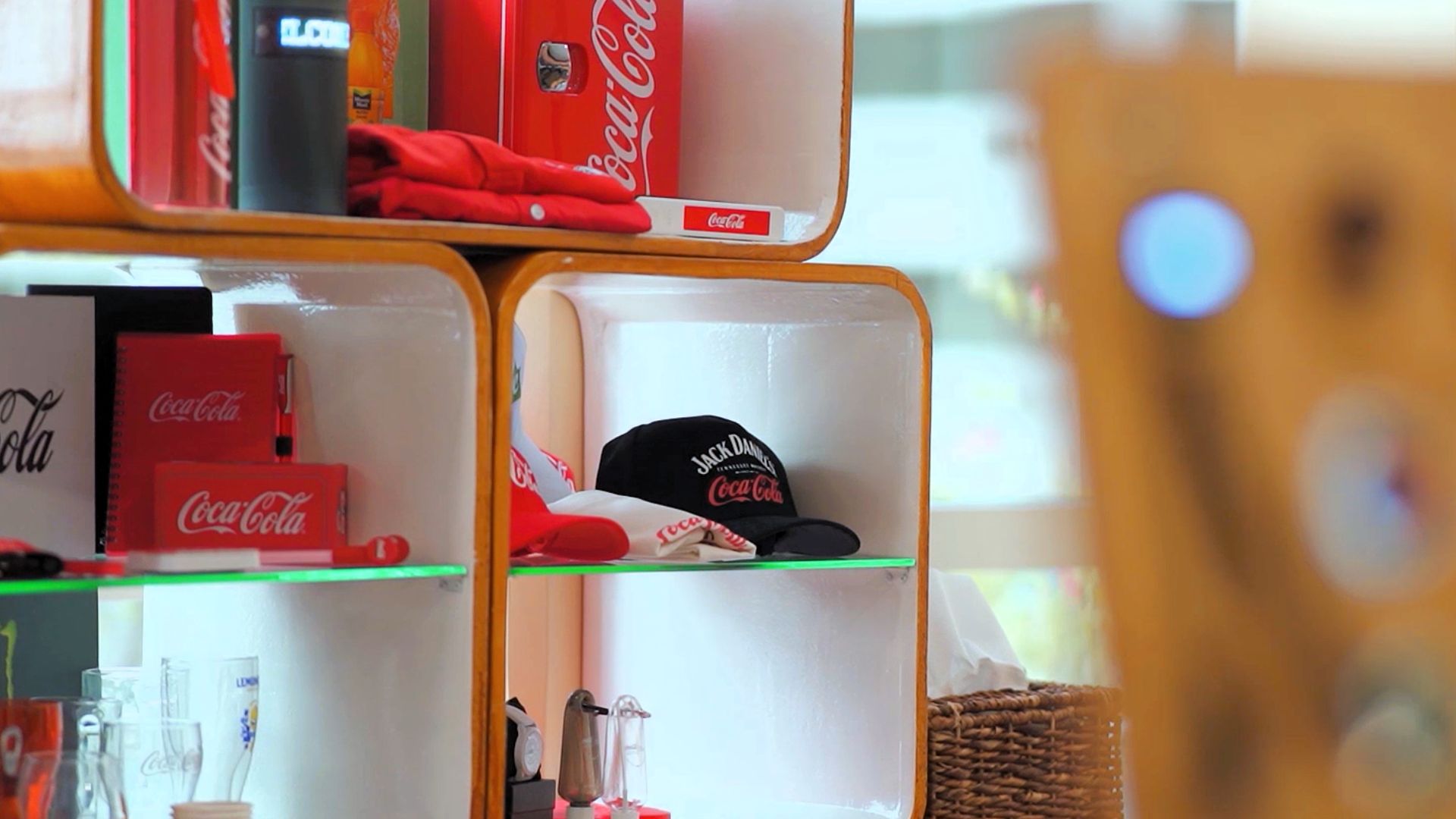 A display case showcasing Coca-Cola merchandise.